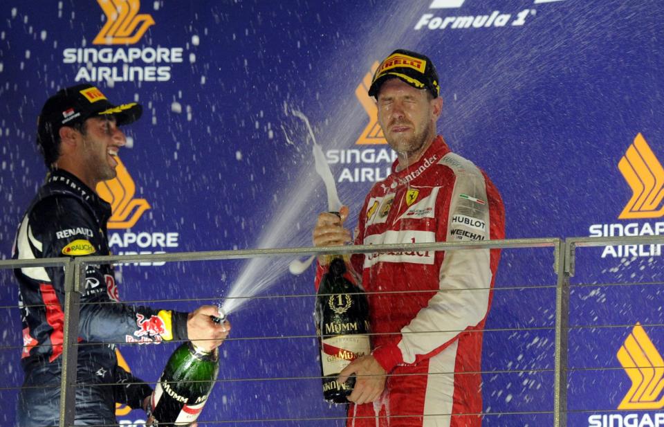 Spray it again Dan: Daniel Ricciardo douses 2015 Singapore Grand Prix winner Sebastian Vettel