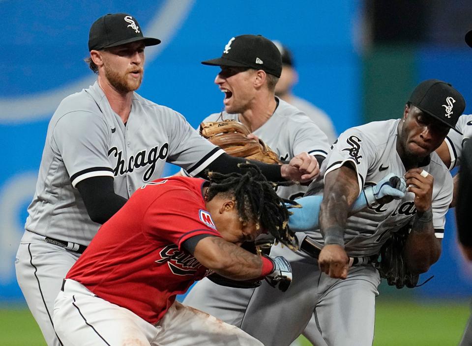 Tim Anderson, right, punches Jose Ramírez, center, in the sixth inning Saturday.