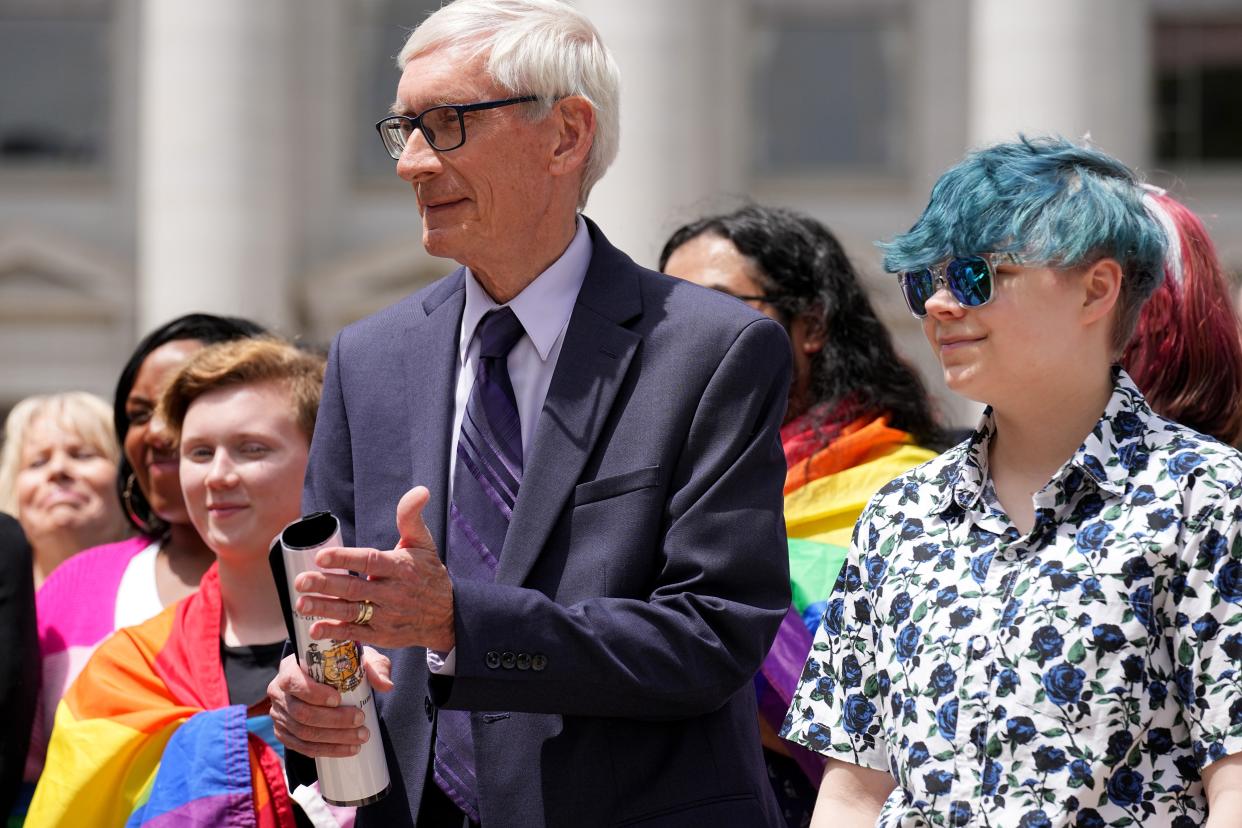 Gov. Tony Evers stands next to 16-year-old Aspen Morris of Appleton at the raising of an LGBTQ flag Wednesday at the Wisconsin Capitol in Madison. The symbol of lesbian, gay, bisexual and transgender pride will be flown over the Capitol’s East Wing in recognition of LGBTQ Pride Month, which runs until the end of June.