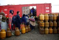 People line up to get a gas cylinder near petrol plant of Senkata, that normalizes fuel distribution in El Alto outskirts of La Paz