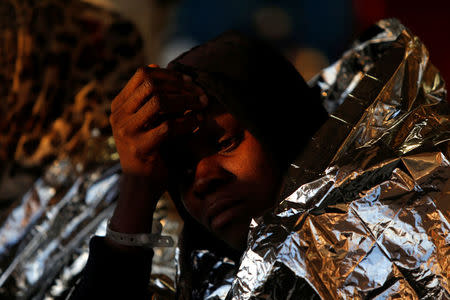 A migrant rests on the Malta-based NGO Migrant Offshore Aid Station (MOAS) ship Phoenix after being rescued from a rubber dinghy in the central Mediterranean in international waters off the coast of Sabratha in Libya, April 15, 2017. REUTERS/Darrin Zammit Lupi