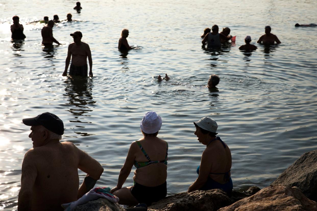 <p>People rest on the beach in Barcelona</p> (Emilio Morenatti/AP)