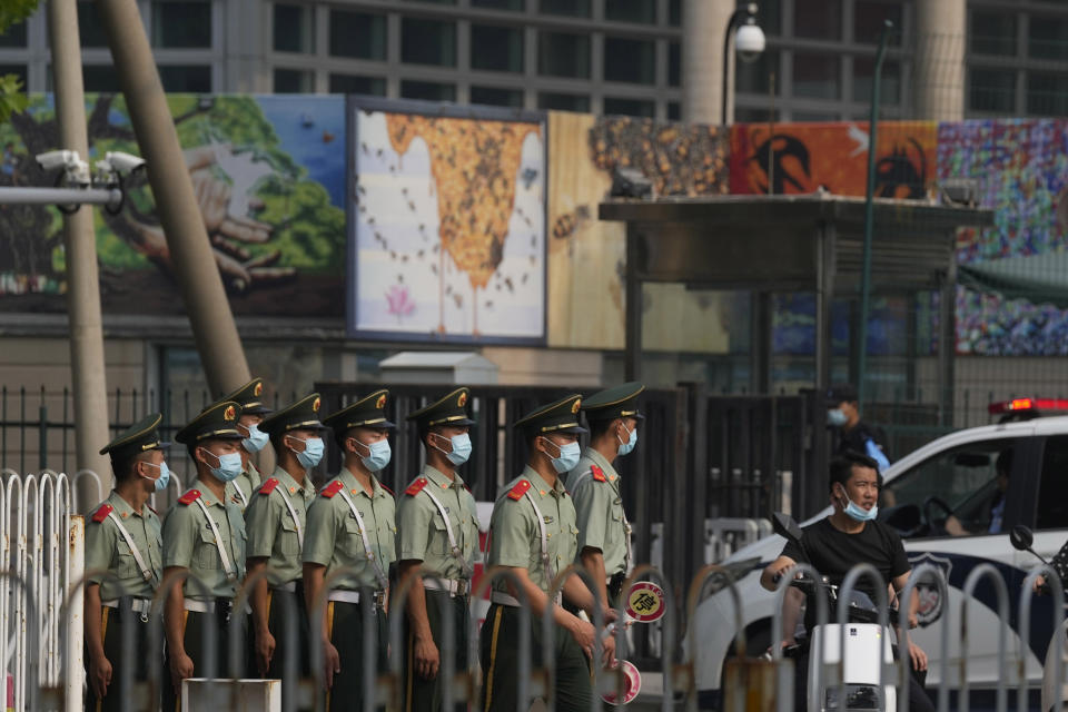 Chinese paramilitary policemen march past the U.S. Embassy in Beijing, Wednesday, Aug. 3, 2022. U.S. House Speaker Nancy Pelosi arrived in Taiwan late Tuesday, becoming the highest-ranking American official in 25 years to visit the self-ruled island claimed by China, which quickly announced that it would conduct military maneuvers in retaliation for her presence. (AP Photo/Ng Han Guan)