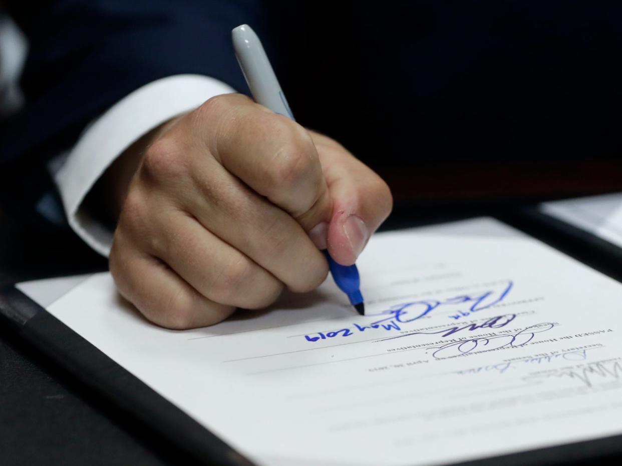 Florida Gov. Ron DeSantis, a Republican, signs a bill into law.