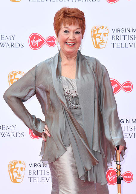 ruth madoc posing at bafta tv awards with walking stilk