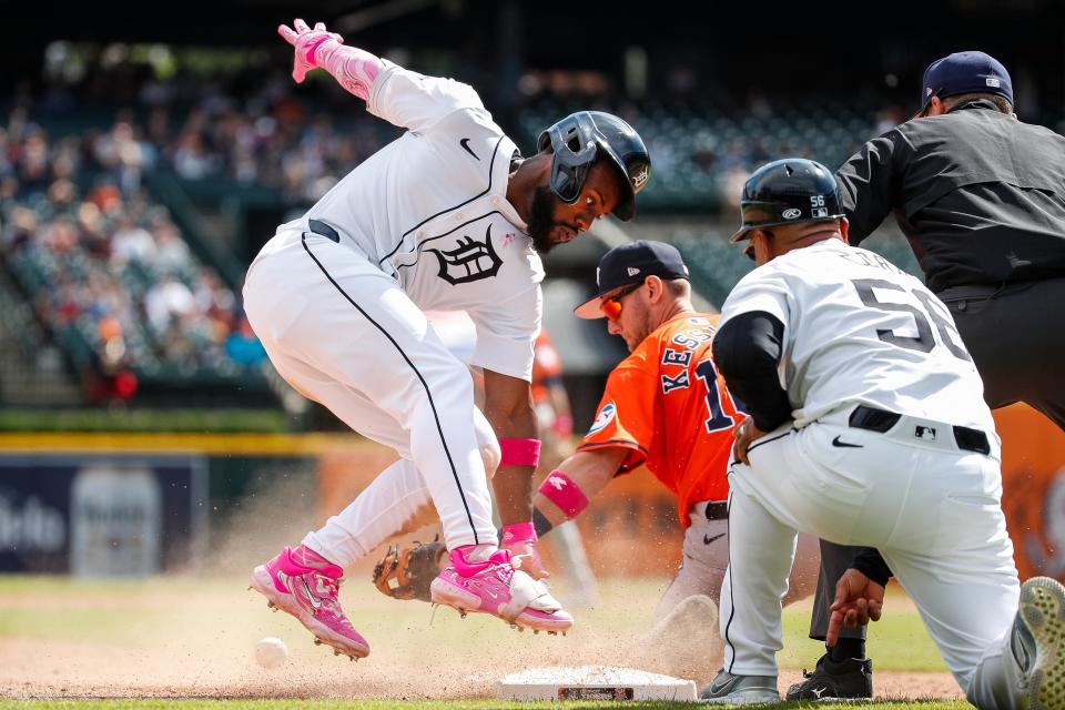 Detroit Tigers center fielder Akil Baddoo touches the third base against Houston Astros third base Grae Kessinger (16) after batting a triple during the ninth inning at Comerica Park in Detroit on Sunday, May 12, 2024.