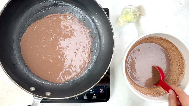 swirling crepe batter in pan