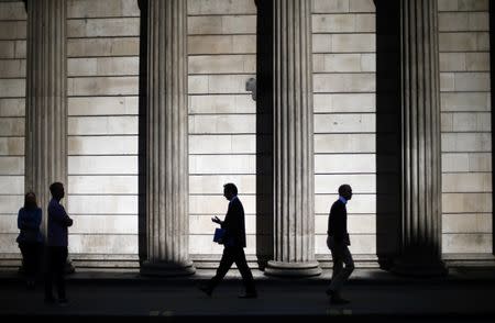 FILE PHOTO - People are silhouetted on a sunny morning as they walk past the columns of the Bank of England in the City of London, May 19, 2014.REUTERS/Andrew Winning