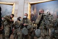 Members of the National Guard walk through the Rotunda of the US Capitol in Washington, DC, January 13, 2021, ahead of an expected House vote impeaching US President Donald Trump. - The Democrat-controlled US House of Representatives on Wednesday opened debate on a historic second impeachment of President Donald Trump over his supporters' attack of the Capitol that left five dead.Lawmakers in the lower chamber are expected to vote for impeachment around 3:00 pm (2000 GMT) -- marking the formal opening of proceedings against Trump. (Photo by SAUL LOEB / AFP) (Photo by SAUL LOEB/AFP via Getty Images)