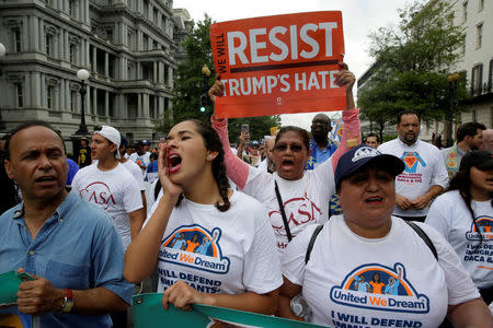 Demonstrators carrying signs march during a rally by immigration activists CASA and United We Dream demanding the Trump administration protect the Deferred Action for Childhood Arrivals (DACA) program and the Temporary Protection Status (TPS) programs, in Washington, U.S., August 15, 2017. REUTERS/Joshua Roberts