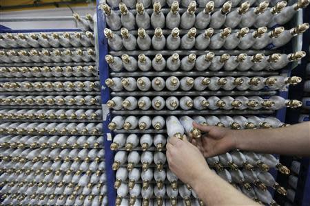 An employee sorts carbonator bottles while working at the SodaStream factory in the West Bank Jewish settlement of Maale Adumim January 28, 2014. REUTERS/Ammar Awad