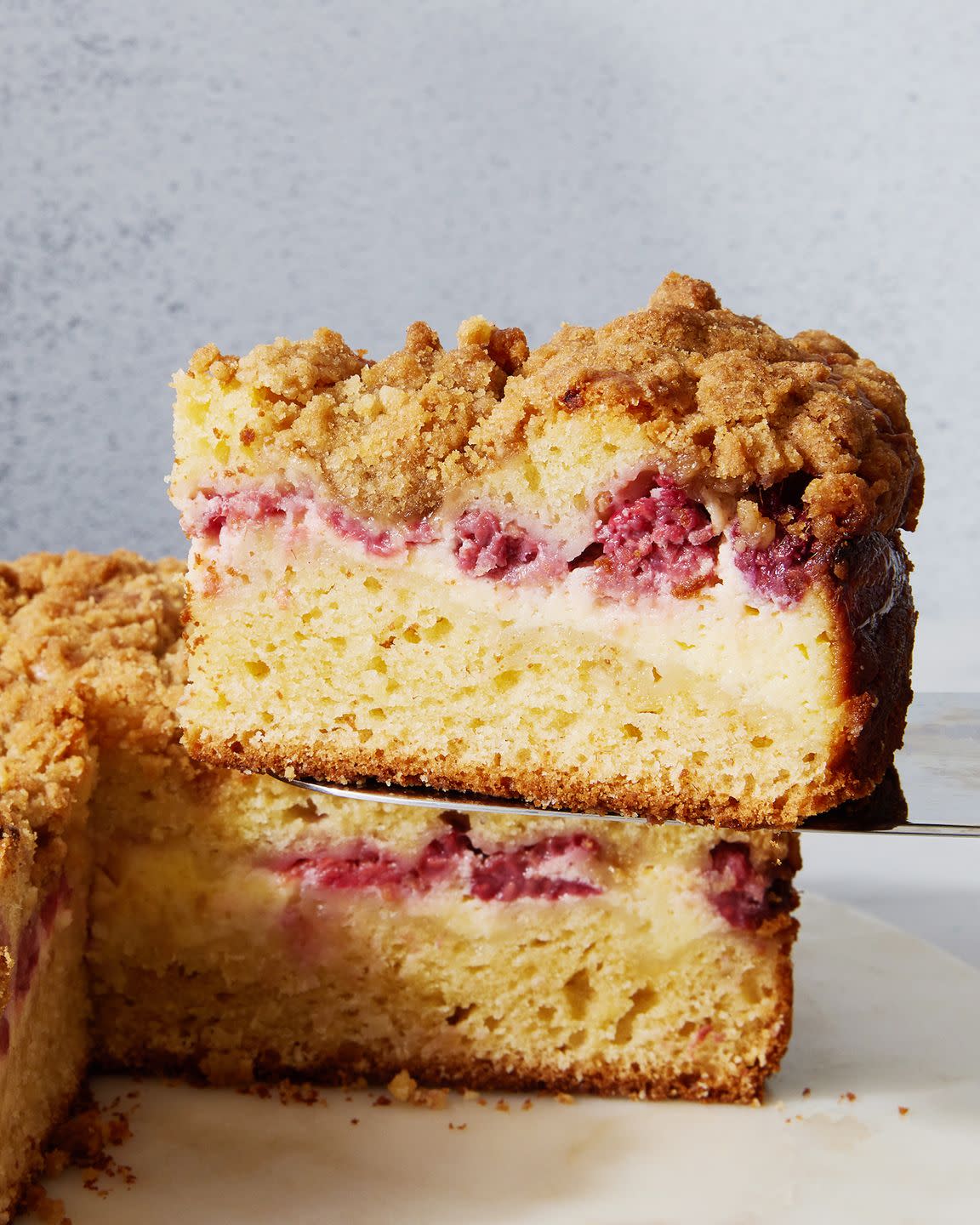coffee cake with layered of raspberry and cream cheese with a crumble topping