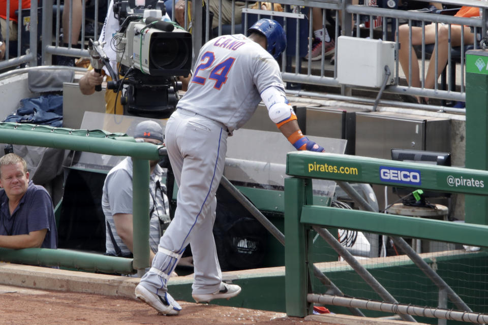 New York Mets' Robinson Cano makes his way to the dugout after injuring his left hamstring while rounding first base during the fourth inning of a baseball game against the Pittsburgh Pirates in Pittsburgh, Sunday, Aug. 4, 2019. (AP Photo/Gene J. Puskar)