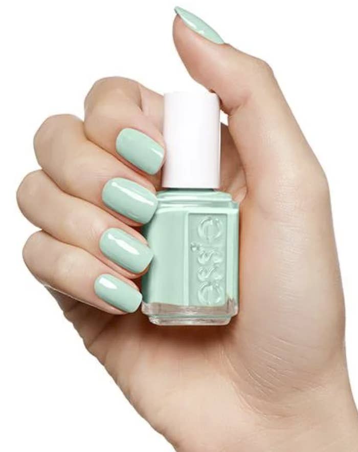 Hand holding mint candy apple nail polish