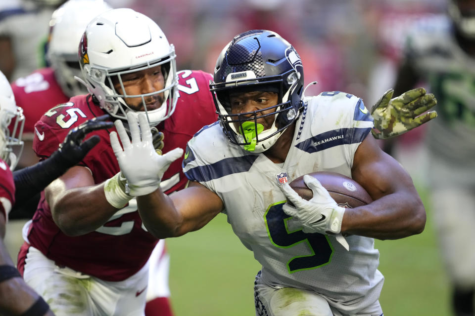 Seattle Seahawks running back Kenneth Walker III (9) runs against Arizona Cardinals linebacker Zaven Collins (25) during the second half of an NFL football game in Glendale, Ariz., Sunday, Nov. 6, 2022. (AP Photo/Matt York)