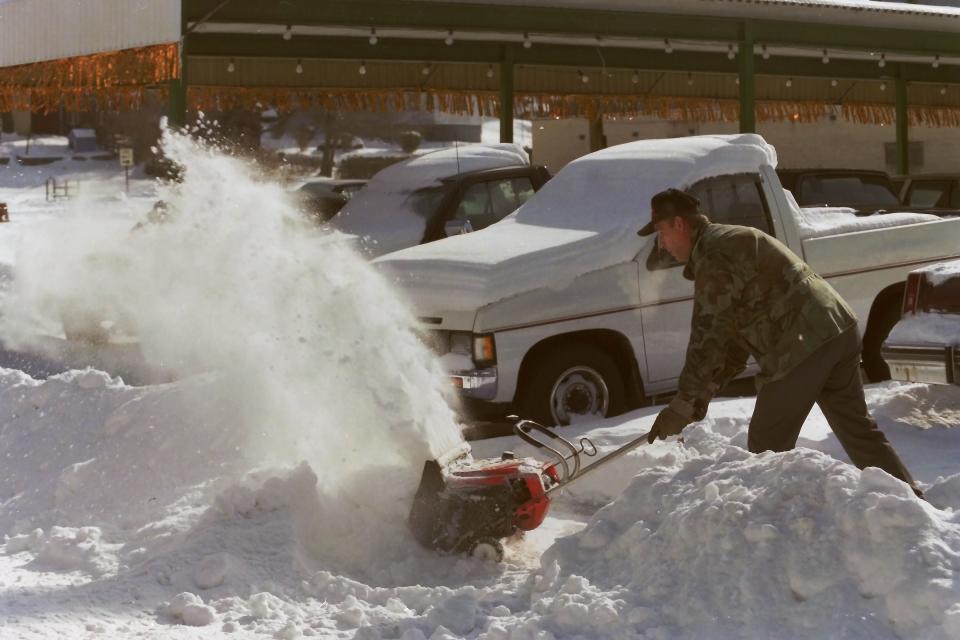 After the large blizzard on March 14, 1993, one New Brighton resident uses a snow blower to move the heavy snow.
