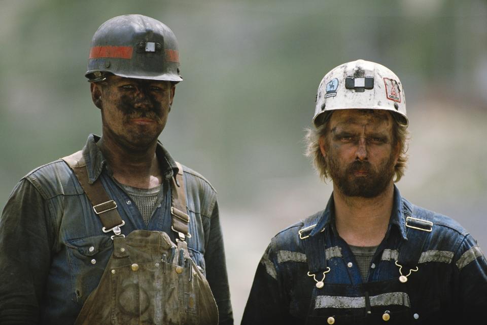 Two coal miners with smudged faces