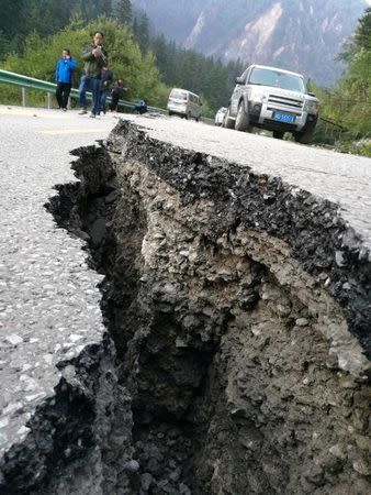 A crack is seen on a road after an earthquake in Jiuzhaigou county, Ngawa prefecture, Sichuan province, China August 9, 2017. CNS/Feng Zheng via REUTERS