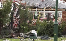 In this imaged made from a video, a firefighter works inside a damaged home following a gas explosion in Christchurch, New Zealand Friday, July 19, 2019. Several people were injured and dozens of homes evacuated in the New Zealand city of Christchurch on Friday after a huge gas explosion destroyed one home and damaged others. (TVNZ via AP)