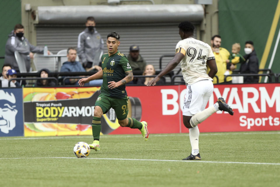 Portland Timbers forward Felipe Mora, left, pushes the ball ahead during an MLS soccer match against Los Angeles FC, Sunday, Sept. 19, 2021, in Portland, Ore. (Sean Meagher/The Oregonian via AP)