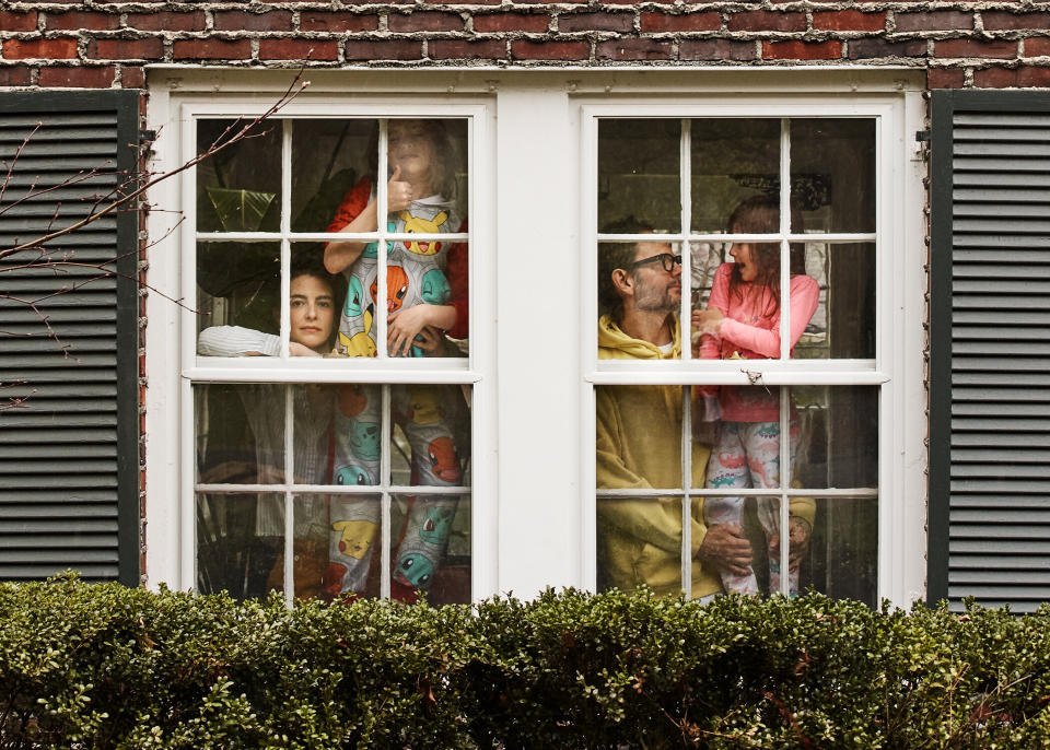 Thomas Osborn (second from right), the creative director and vice president of education for TIGI Americas, and Mariel Osborn, director of production at LaMer, with their son, 7, and daughter, 4. <br /><br />"My husband and I are incredibly lucky to still be employed, so we are still getting up early and hitting the computers for Zoom meetings ALL. DAY. LONG," Mariel said. During the days, "there's usually crying and screaming at some point, mostly from the kids, sometimes from the parents, sometimes from everyone."