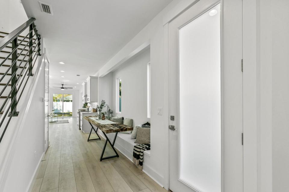 From the entry foyer, it's a straight shot through the dining area, kitchen, living area and sliding glass doors. The 2-by-10-foot dining table was custom-built using planks from the old Jacksonville Beach pier, and conveys with purchase.