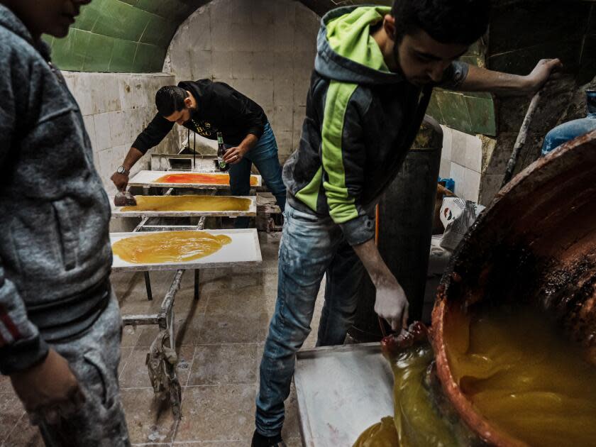 Turkish delight maker spreading out gelatin