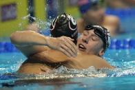 Chase Kalisz hugs Jay Litherland after winning Men's 400 Individual Medley during wave 2 of the U.S. Olympic Swim Trials on Sunday, June 13, 2021, in Omaha, Neb. (AP Photo/Jeff Roberson)