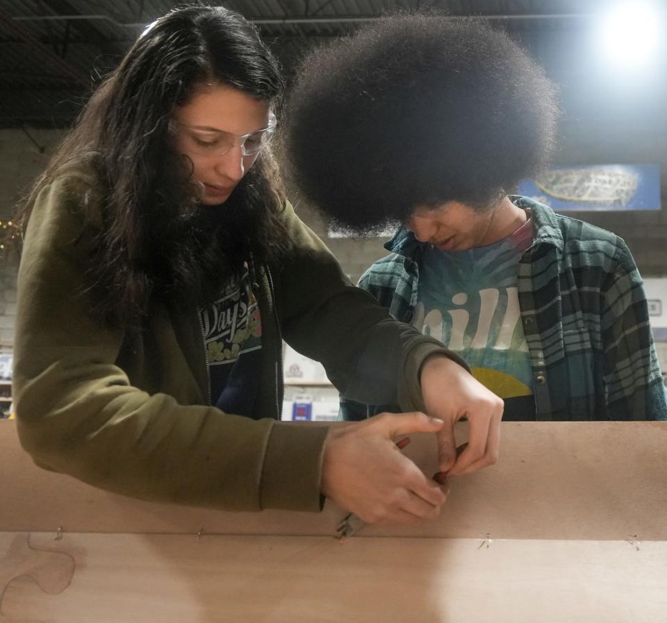 Sisters Meme Marshall, left, and Mari Marshall cut wires together during the hands-on educational experience building a boat Monday, Feb. 5, 2024, at All Hands Boatworks in Milwaukee. Their favorite part about the class is spending time with each other and learning new skills.