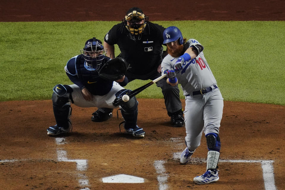 Los Angeles Dodgers' Justin Turner hits home run against the Tampa Bay Rays during the first inning in Game 3 of the baseball World Series Friday, Oct. 23, 2020, in Arlington, Texas. (AP Photo/Sue Ogrocki)