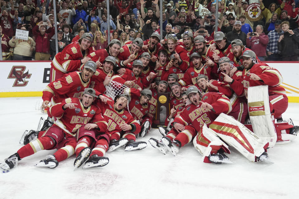 Denver poses with the championship trophy after defeating Boston College in the championship game of the Frozen Four NCAA college hockey tournament Saturday, April 13, 2024, in St. Paul, Minn. Denver won 2-0 to win the national championship. (AP Photo/Abbie Parr)