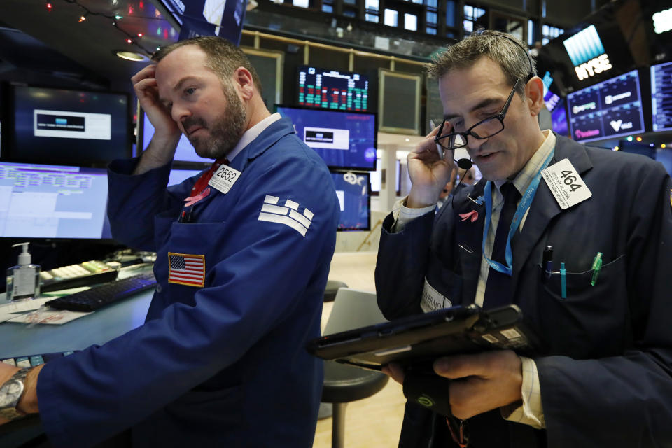 Specialist Charles Boeddinghaus, left, and trader Gregory Rowe work on the floor of the New York Stock Exchange, Thursday, Dec. 27, 2018. Wall Street's wild Christmas week goes on, with the Dow Jones Industrial Average slumping 300 points at the open Thursday, a day after notching its biggest-ever point gain. (AP Photo/Richard Drew)