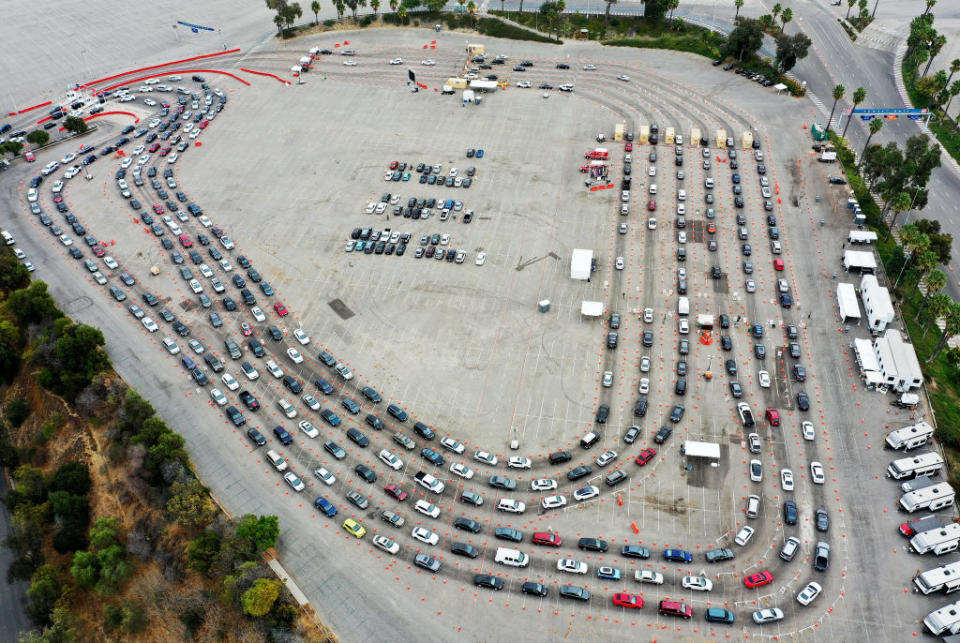 Hundreds of cars line at a Dodger Stadium for testing. 