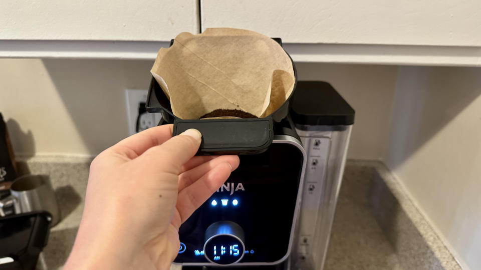 Placing brew basket with the filter in the machine