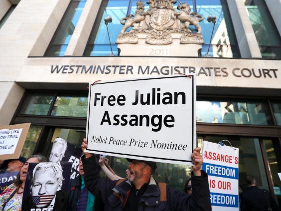 Pro-Assange protesters outside Westminster Magistrates’ Court today (AP)