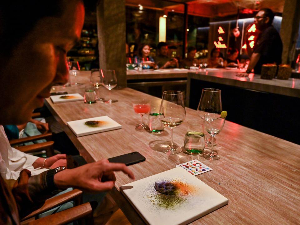 A diner looking at a dish during the opening of chef Gaggan Anand's new eponymous restaurant in Bangkok.