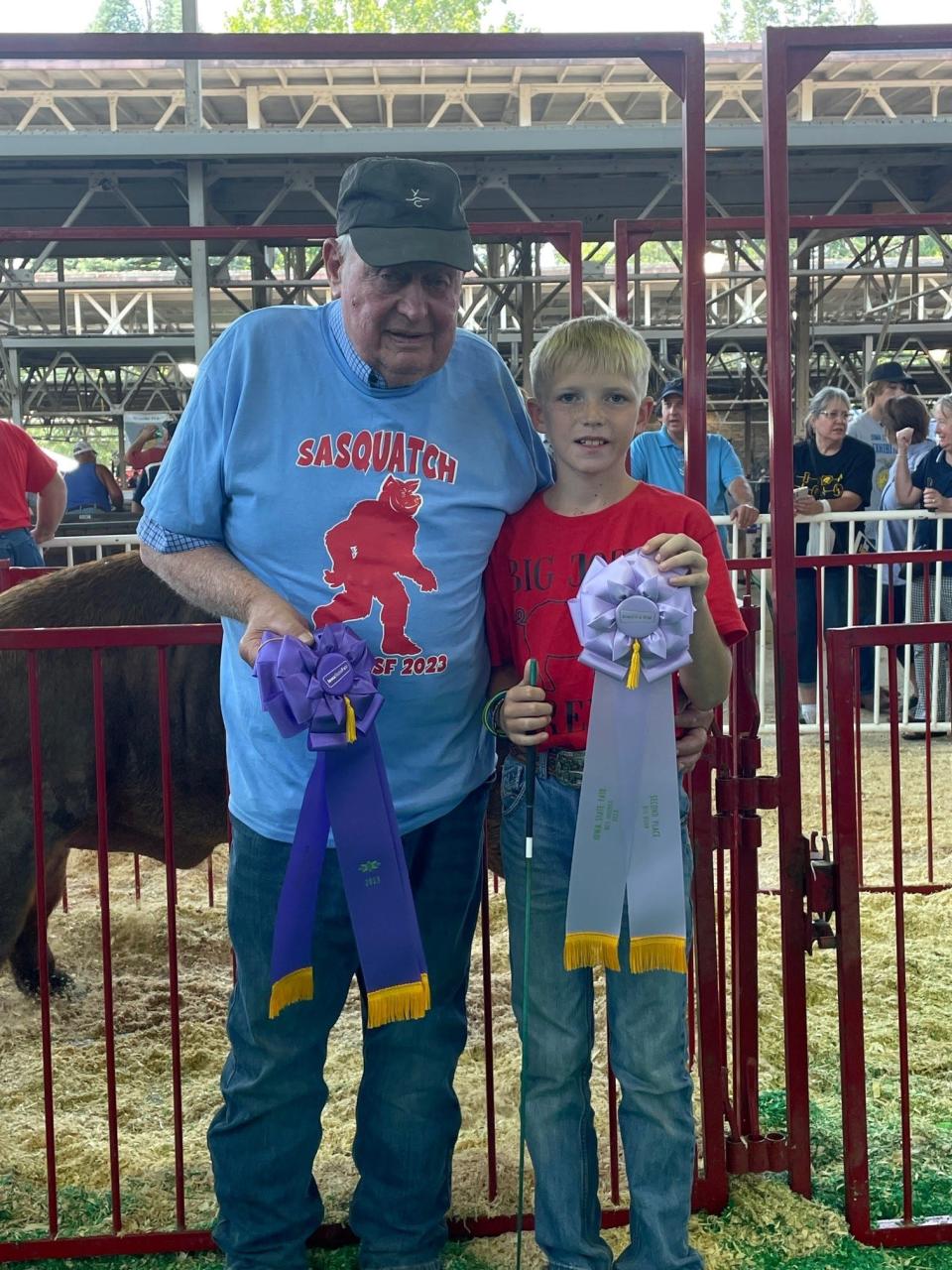 Wilbur Kehrli, whose family pig won Big Boar, poses with Jack Theobald, who represents the future of the contest.