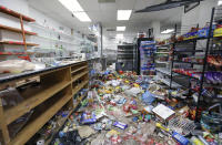 Food and other items are strewn on the floor of African Food & Liquor in Chicago, Thursday, Aug. 13, 2020. The West Side convenience store was ransacked Monday just hours after Chicago Mayor Lori Lightfoot warned vandals that the city will hold them accountable for ransacking downtown retailers earlier that day. It was the second time since May that the neighborhood store was vandalized. (AP Photo/Teresa Crawford)