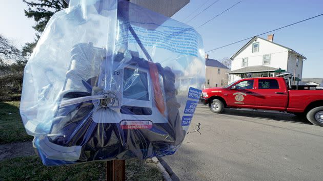 A air quality monitoring device hangs on a stop sign in East Palestine, Ohio, in mid-February. 