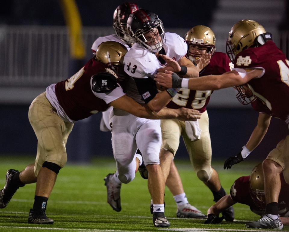 North Posey’s Jed Galvin (33) is tackled by Mater Dei Wildcats defenders as the North Posey Vikings play the Mater Dei Wildcats at the Reitz Bowl in Evansville, Ind., Friday evening, Nov. 4, 2022.