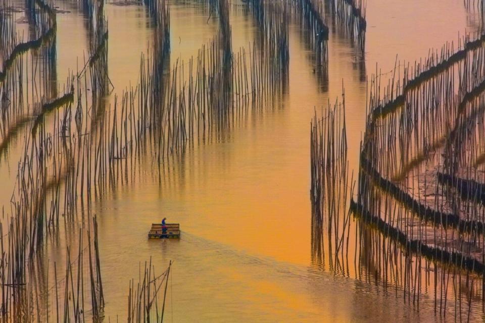 The sunset casts a golden light on the water in Xiapu.