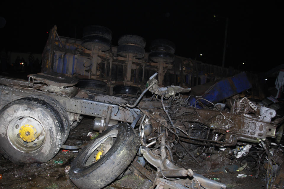 The wreckage of vehicles lies on the ground after a fatal accident in Londiani, Kenya early Saturday, July 1, 2023, at a location known for crashes about 200 kilometers (125 miles) northwest of the capital, Nairobi. Dozens were killed when a truck rammed into several other vehicles and market traders on Friday evening, police said. (AP Photo)