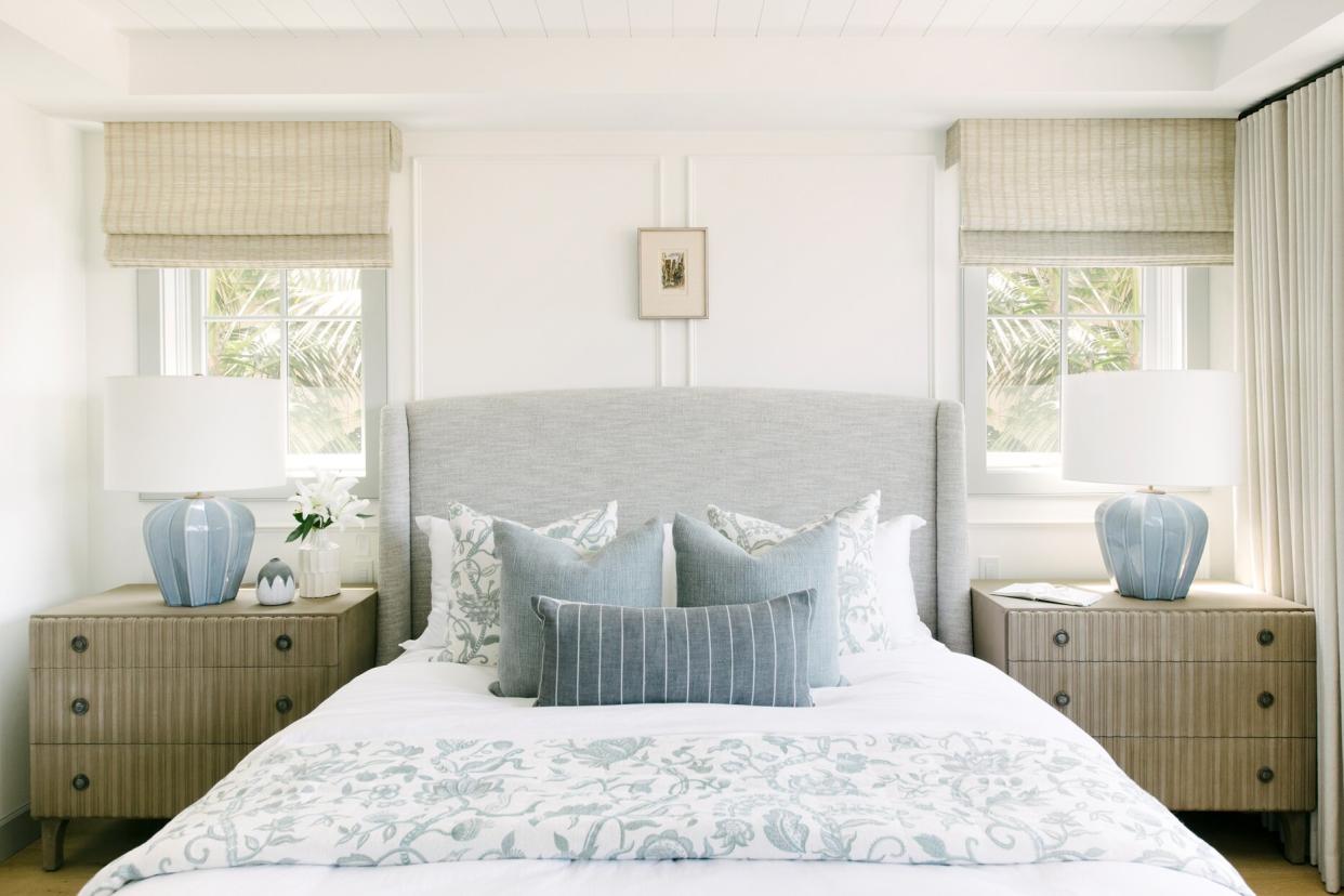 master bedroom blue-gray and white patterned bedding with double nightstand and lamp sets