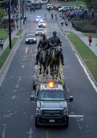 The statue of Confederate general Robert E. Lee is escorted after removal from its platform in Dallas, Texas, U.S., September 14, 2017. REUTERS/Rex Curry