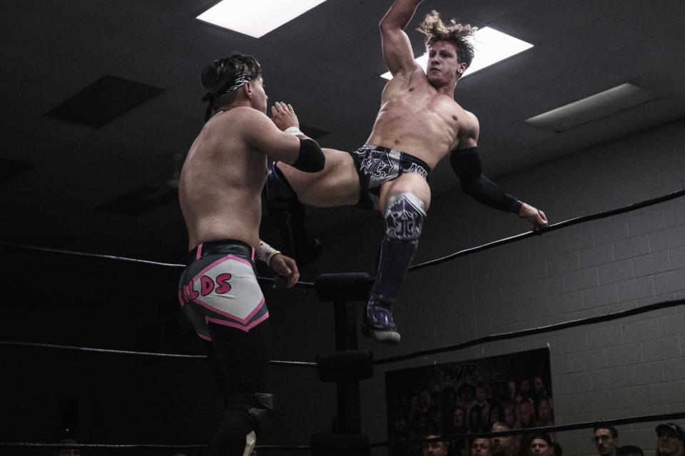 IWR KJ Reynolds, left, receives an Enziguri to the side of the face from IWR United States Champion Ace Austin.