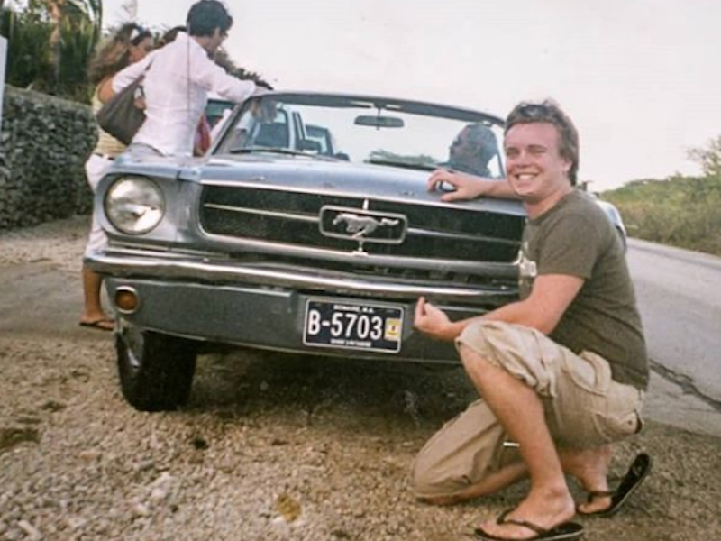 Fabrizio posing next to his first Mustang.