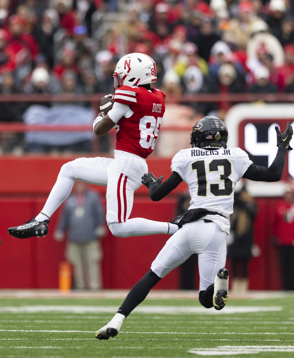 Nebraska's Jaidyn Doss (85) catches a pass against Purdue's Derrick Rogers Jr. (13) during the first half of an NCAA college football game Saturday, Oct. 28, 2023, in Lincoln, Neb. (AP Photo/Rebecca S. Gratz)