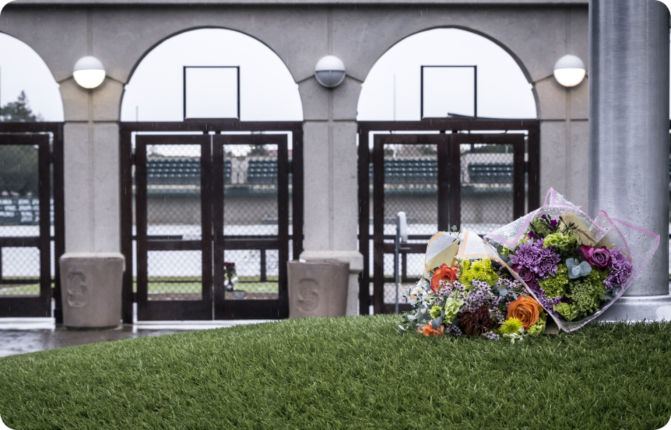 two bouquets of flowers lie at the base of a flagpole outside maloney field at stanford university, where the soccer team practiced on march 3, two days after the death of katie meyer, a student and standout soccer player for the university