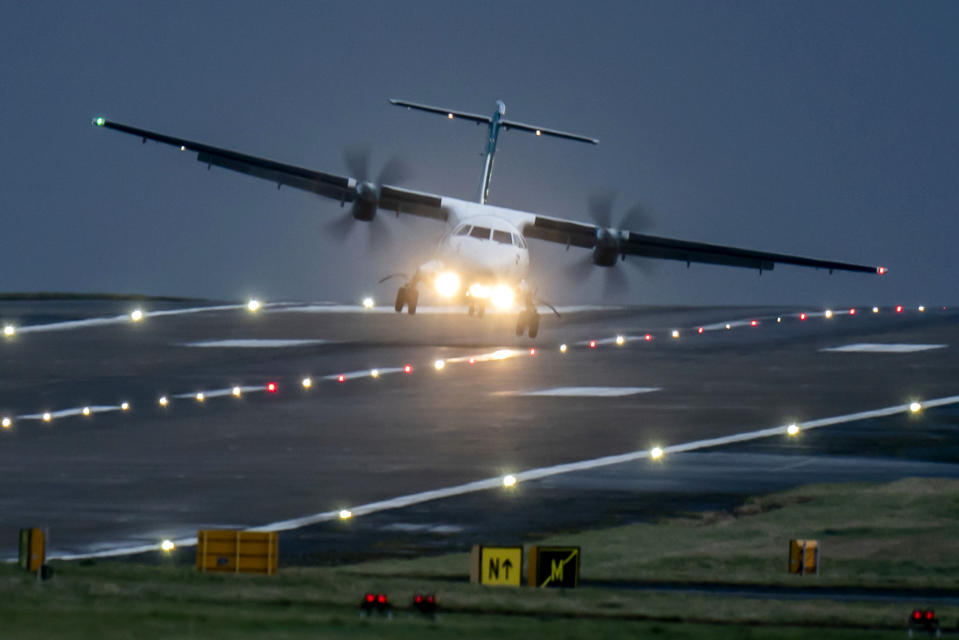 A aircraft lands at Leeds Bradford Airport, England, Thursday, Dec. 21, 2023. Storm Pia is expected to cause disruption in parts of Scotland, the north of England and Northern Ireland. (Danny Lawson/PA via AP)