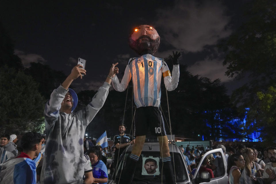 Fans waits for the arrival of the Argentine soccer team that won the World Cup outside the AFA training grounds in Buenos Aires, Argentina, late Monday, Dec. 19, 2022. (AP Photo/Matilde Campodonico)